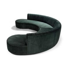 the curved sofa is made from green velvet