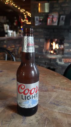 a beer bottle sitting on top of a wooden table