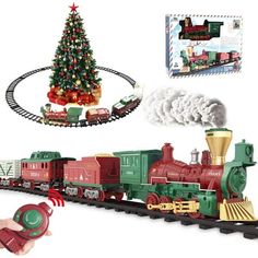 a toy train set with a christmas tree on the track and other toys around it