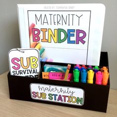 a box with markers, crayons and pencils in it on a table