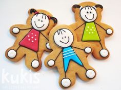 three decorated cookies with children's faces on them are sitting next to each other