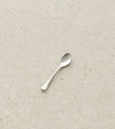 a silver spoon sitting on top of a white counter