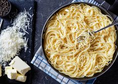 a pan filled with pasta and cheese on top of a table