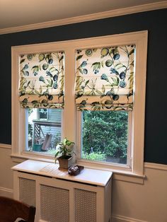 two windows in a room with blue walls and white trim on the window sill