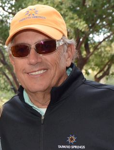 an older man and young woman posing for a photo in front of trees wearing sun glasses