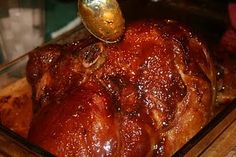 a large piece of meat sitting on top of a wooden cutting board