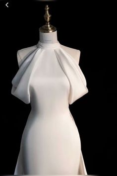 a mannequin is dressed up in white