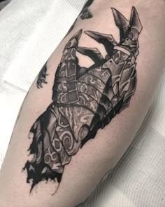 a black and white tattoo on the arm of a man with an origami design