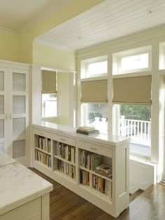 an empty room with bookshelves and cabinets in it