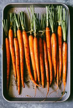 carrots are sitting on a baking sheet and ready to be cooked in the oven