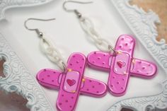 Pride Month Sale! Discount: 20% off when you buy 2 items + free pride themed jewelry gift! Promo code: HAPPYPRIDEMONTH Add a touch of charm to your outfit with these adorable pink bandage earrings. Designed for those who treat boo boos, these earrings are perfect for nurses, teachers, or anyone who loves to accessorize with a fun twist. Whether you're treating yourself or surprising a loved one, these earrings make for a thoughtful and stylish gift that is sure to stand out. The vibrant pink color adds a playful pop to any look, making them ideal for both casual and dressier occasions. Lightweight and comfortable to wear, these earrings are as practical as they are eye-catching. Elevate your accessory game with these delightful pink bandage earrings today! As with all of my products, these Nurse Earrings, Medical Jewelry, Jewelry Hanger, Jewelry Care Instructions, Acrylic Charms, Gift Cute, Jewelry Tray, Jewelry Unique, Earring Hooks