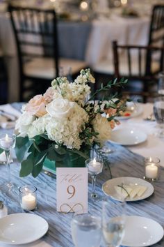 the table is set with flowers and candles