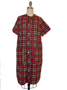 Adorable 1960s vintage house dress. This plaid, cotton blend dress is lightweight and perfect for summer. It is a versatile piece, as it can be worn as a dress or a tunic.  Button down front with two oversized pockets. Charming and petite collar adds a feminine touch. In excellent vintage condition, seemingly never worn  Shoulders 15" Bust 40" Sleeves 9" Length 37" Casual Cotton Plaid Dress With Buttons, Cotton Plaid Dress With Buttons For Daywear, Retro Plaid Dress For Daywear, Plaid Cotton Dress With Buttons, Collared Cotton Plaid Dress, Vintage Lined Plaid Dress, Vintage Cotton Plaid Dress, Vintage Plaid Sleeveless Dress, Vintage Fitted Plaid Cotton Dress