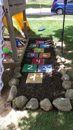 a child's play area with rocks and numbers