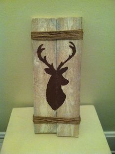 a wooden block with a deer head painted on it