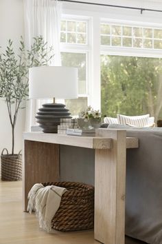 a living room with a couch, table and lamp in it's centerpiece