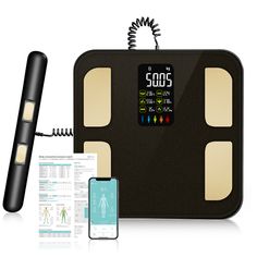 an electronic body composition scale with thermometer and cell phone next to it on a white background