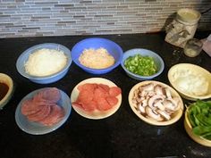 several bowls with different types of food in them on a counter top next to a blender