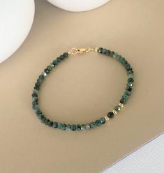 This dainty emerald bracelet is available in 14k gold filled or sterling silver.  It's beaded with off center smooth metal bead and finished with a lobster claw clasp. This bracelet looks great on it's own and pairs well with other bracelets for a pop of color. A great handmade birthstone jewelry gift for a May birthday girl or a special girl on any occasion.   Please select your wrist size and metal preference from the drop down menu at check out.  The emerald rondelles and smooth metal beads a Everyday Faceted 14k Gold Filled Bracelets, Everyday 14k Gold-filled Bracelets With Gemstone Beads, Everyday 14k Gold Filled Gemstone Beads Bracelets, Adjustable Faceted 14k Gold Filled Bracelets, Everyday 14k Gold Filled Bracelets With Gemstone Beads, Dainty 14k Gold-filled Bracelets With Gemstone Beads, Gold Bracelets With Tiny Beads For Healing, Elegant May Birthstone Beaded Bracelets With Faceted Beads, Elegant May Birthstone Faceted Beaded Bracelets