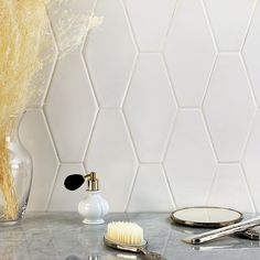 a bathroom counter with a brush, comb and mirror