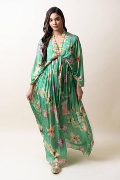 Green chiffon kaftan dress with floral print and sequins hand embroidered placket and neckline. Comes with an inner.
Components: 2
Pattern: Printed, Hand embroidered
Type Of Work: Floral, Sequins
Neckline: V Neck
Sleeve Type: Flared Sleeves
Fabric: Chiffon
Color: Green
Other Details: 
Length : Dress - 57 inches
Occasion: Party - Aza Fashions Floral Print V-neck Kaftan For Party, Long Sleeve Chiffon Kaftan For Spring, Embellished Silk V-neck Maxi Dress, Festive Printed Dresses With Kimono Sleeves, Vacation Georgette Maxi Dress, Green Floral Print Maxi Kaftan, Festive Printed Dress With Kimono Sleeves, Green Silk Floor-length Kaftan, Green Embellished Chiffon Dress