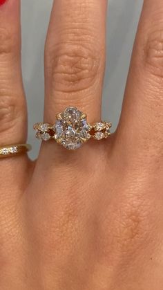 a woman's hand with a ring on it and a diamond in the middle