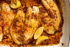 chicken with lemons and spices in a pan