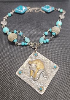 Beautiful and one of a kind, hand made silver and turquoise colored beads featured by a vintage pendant that has a unique image of an Ancient Egyptian King. The beads I used are silver,  stone, crystal and pottery.   The pendant measures 3 inches by 3 inches.   The necklace length is adjustable.  I love this necklace, I hope you will too!  Gift wrapped year round! Handmade Antique Silver Jewelry For Collectors, Artisan Silver Beaded Necklace Nickel Free, Handmade Antique Silver Amulet Necklace, Artisan Turquoise Necklace With Silver Beads As Gift, Handmade Turquoise Metal Necklace, Nickel Free Sterling Silver Vintage Turquoise Necklace, Vintage Sterling Silver Turquoise Necklace, Nickel-free, Vintage Sterling Silver Turquoise Necklace Nickel-free, Vintage Sterling Silver Turquoise Necklace, Nickel Free