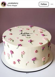 a white cake with pink flowers on it