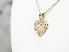 This seed pearl heart pendant is utterly sweet! A polished, openwork design lets lots of light into the piece, allowing the gold to shine brightly. Tiny seed pearls and a sparkling diamond add elegance and femininity, making this piece a lovely choice for an anniversary gift or bridal pendant. This pendant does not come with the chain shown. Please feel free to contact us, we will help you find the perfect chain for your style and budget! Metal: 14K Yellow Gold Gem: Diamond .03 Carats Gem Measur Fine Jewelry Heart Pendant Necklace For Wedding, Wedding Heart Pendant Necklace In Fine Jewelry Style, Wedding Heart Necklace With Pearl Pendant, Wedding Fine Jewelry Heart Pendant Necklace, Open Heart Birthstone Necklace For Wedding, Delicate Diamond Heart Necklace For Wedding, Wedding Pearl Heart Pendant Necklace, Yellow Gold Heart Necklace With Diamond Cut For Wedding, Fine Jewelry Yellow Gold Heart Necklace For Wedding