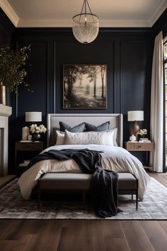 a bedroom with black walls and white bedding in the center, along with a fireplace