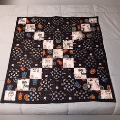 a black and white quilt with pictures on it