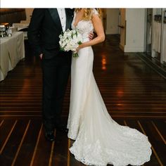 a bride and groom posing for a photo in their wedding reception room at the hotel