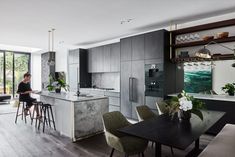 a modern kitchen with marble counter tops and stainless steel appliances