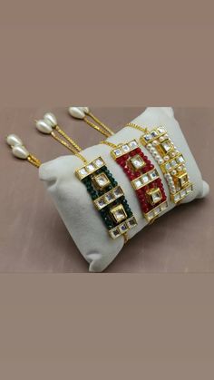 three pieces of jewelry sitting on top of a white bag