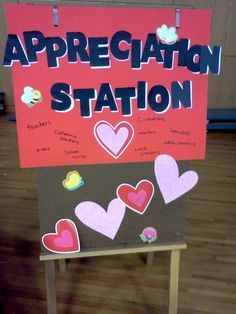 a sign that says appreciation station with hearts attached to the front and back of it