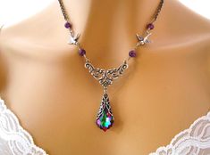 "Antiqued Silver Art Nouveau Purple Bridesmaids Necklace Baroque Swarovski Electra Purple Crystal Necklace Amethyst Birds Bridal Jewelry Wedding Jewelry This NEW Swarovski crystal color has incredibly beautiful deep purples, mixed with green, fuchsia, blue and gold! I've used it to make a romantic Baroque/Victorian style purple crystal bridesmaids necklace featuring the luscious Electra purple Swarovski crystal pendant encased in an awesome antiqued silver filigree wrap. The pendant dangles belo Purple Jeweled Wedding Necklace, Purple Necklaces With Intricate Design For Wedding, Purple Wedding Necklaces With Intricate Design, Purple Wedding Necklace With Intricate Design, Purple Crystal Necklace, Purple Bridesmaids, Necklace Amethyst, Purple Crystal, Bridesmaid Necklace