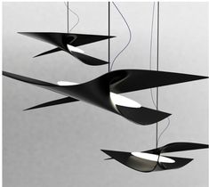 three suspended lights that are black and white