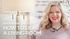 a woman standing in front of a lamp with the words how to light a living room