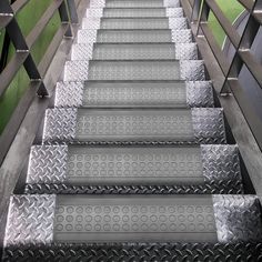 several metal steps going up and down in the same direction