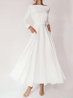 a woman is wearing a white dress with long sleeves and a bow at the waist