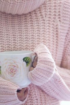 a close up of a person holding a coffee cup