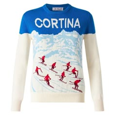 a blue and white sweater with red skis on it that says cortina