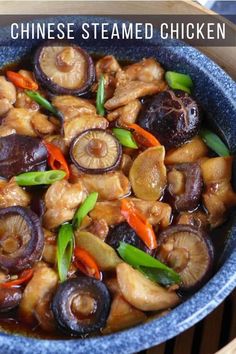 chinese steamed chicken with carrots and onions in a blue bowl