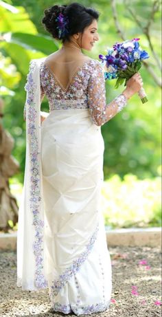 a woman in a wedding dress holding flowers