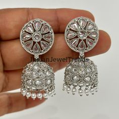 Silver Polki Jhumka/Stone Jhumka/Indian earrings/Indian Jewelry/Pakistani/Punjabi/Indian/Statement earring/Bridal earring/Indian wedding Product Weight = 19.5 grams approx Height = 45 mm || Width = 22 mm Classic Jhumki Antique Earring This is 100% Handmade jewelry. So Color, shades, and texture displayed may vary slightly from the actual product due to digital image limitations. We request you to consider these minor variations. Please expect the possibility of some slight imperfections when buying handmade jewelry. If you have any questions, please message or email us. Arrives in gift box. Please let me know if you have any questions. Thank you so much visiting my shop. Silver Chandelier Earrings With Stone Work For Festivals, Traditional American Diamond Jhumkas For Festivals, Traditional Silver Chandelier Earrings For Wedding, Festive Silver Chandelier Earrings With Stone Work, Silver Jhumkas For Wedding, Silver Kundan Chandelier Earrings For Wedding, Silver Bollywood Style Drop Jhumkas, Silver Bollywood Jhumkas With Matching Earrings, Silver Kundan Bridal Earrings For Eid