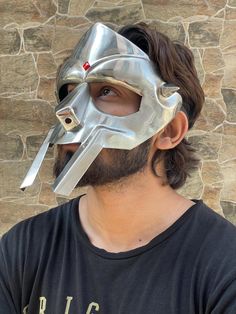 Tribute to Legend Singer MF Doom 1. It's limited Eddition Mf doom mask. 2. Perfect Mirror Chrome Finish. 3.it's steel Mask. 4. You can choose material according to your desier. 5. It has 2 spikes in sides as same as On Legend MF Doom Mask. 6. It Also Have Adjustable Leather Straps so you can Comfortably Wear it. 7. It Has a artifical Gem stone on Forhead. 8. Overall Length : 9.75 ( Approx ) 9. Width : 8.25 ( Approx ) 10. If we talk about size so it comes in free size which is suitable for all adults . 11. It Ideal for Re- enactment, Role-play, SCA Etc. 12. Can be used as a Decorative master piece in your collection, Home & Office and Tribute to Legend MF Doom . If you have any questions to ask so feel free and contact me anytime, i m always here for you ! Doom Mask, Mf Doom Mask, Armor Medieval, Doom 1, Mask For Halloween, Mf Doom, Forged Steel, Halloween Masks, Hand Forged