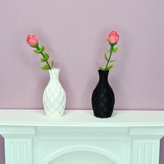 two vases with flowers are sitting on a mantel in front of a purple wall