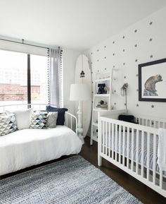 a baby's room is decorated in white and blue