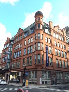 an old brick building on the corner of a street